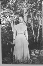 SA0173 - A full length portrait of Emma M. Freeman standing under a birch tree. Identified on the back. See comment field for SA 0198.